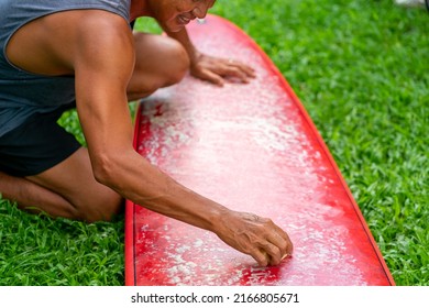 Healthy Asian senior man waxing surfboard surface at home. Active elderly male surfer enjoy outdoor lifestyle surfing at the sea on summer vacation. Retirement people activity and water sport concept. - Powered by Shutterstock