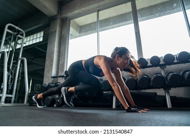 Healthy Asian woman athlete do running plank workout exercise body weight lifting at fitness gym. Attractive girl do body muscle building weight training at sport club. Health care motivation concept - Powered by Shutterstock