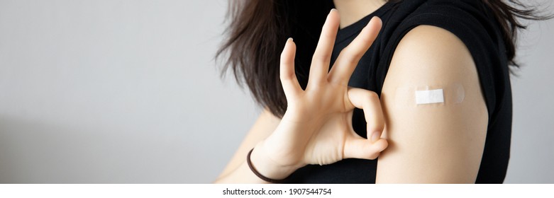 Healthy asian woman getting vaccinated immunity giving ok hand sign to rolling out vaccine, concept of recommended inoculation, vaccination, vaccinated patient, vaccine roll-out program - Shutterstock ID 1907544754