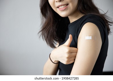Healthy asian woman getting vaccinated immunity giving thumb up to vaccine program, concept of recommended inoculation, vaccination, vaccine volunteer or vaccinated patient