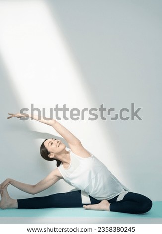 A healthy Asian woman is stretching.