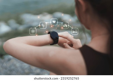 Healthy Asian woman is warm up before jogging and checking sport app on smartwatch. Fitness girl running. Female exercising at outdoor park - Powered by Shutterstock