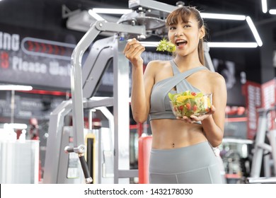 Healthy Asian Young Woman Happy Eating Vegetables Green Salad At Gym. Fitness And Healthy Food , Lose Weight Concept