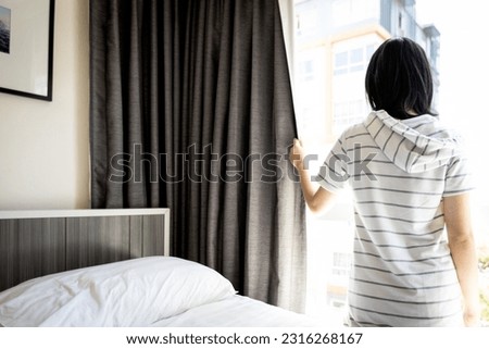 Healthy asian young woman opening curtains and windows for hygienic,sunlight to enter her bedroom and air circulate freely in room,prevent disease and illness,lifestyle,health care,hygiene concept