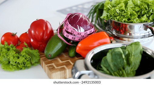 Healthy Assorted Culinary Vegetable Ingredient. Purple Round Cabbage Wrapped in Pink Centimeter. Green Sorrel in Pan. Organic Pepper and Avocado Fruit on Cutting Board Horizontal Photography - Powered by Shutterstock