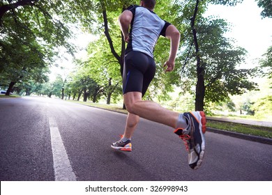 Healthy Athlete Man Jogging At Morning On Empty  Roat In The City