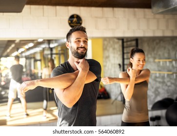 Healthy athletes exercising at gym.