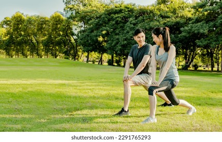 Healthy and attentive asian couple playing sports pre workout warm up together prevent and reduce injury on garden lawn on sunny summer morning : Sports health care and recreational activities concept - Powered by Shutterstock