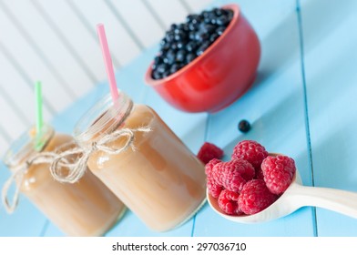 Healthy Baby Food: Apple Banana Or Apricot Puree In Mason Jar, Fresh Raspberry At Wood Spoon. Light Rural Wooden Background. Unique Perspective, Selective Focus.