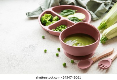 Healthy baby food in bowl.  Baby food vegetable puree with broccoli and peas