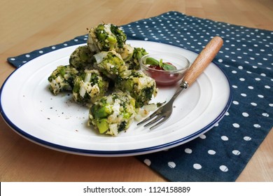 Healthy Baked Broccoli Tots With Ketchup And Basil (white Plate, Wooden Table, Wooden Fork, Blue And White Dot Placemat)