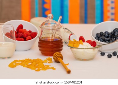 Healthy balanced Breakfast of cereals and dairy products with berries and honey on a colored background. - Powered by Shutterstock