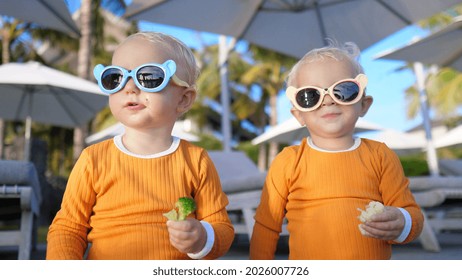 Healthy Balanced Diet For Toddlers - Twin Girls Snacking With Broccoli And Cauliflower At The Poolside