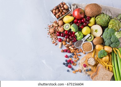 Healthy balanced dieting concept. Selection of rich fiber sources vegan food. Vegetables fruit seeds beans ingredients for cooking. Copy space background, top view