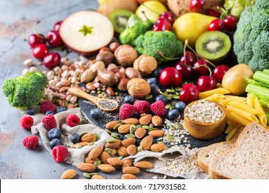 Healthy balanced dieting concept. Selection of rich fiber sources vegan food. Vegetables fruit seeds beans ingredients for cooking - Shutterstock ID 717931582