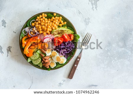 Healthy balanced vegetarian food concept, buddha bowl salad. Avocado, spinach, chickpeas, vegetable appetizer plate