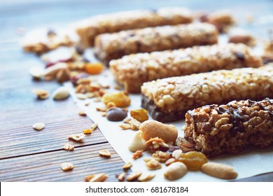 Healthy bars with nuts, seeds and dried fruits on the wooden table, with copy space. - Powered by Shutterstock