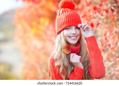 Healthy, beautiful smile, cute kid with dental braces smiling . Portrait of a little girl with orthodontic appliance. Beautiful girl walking outdoors in autumn