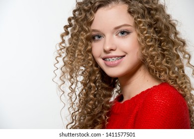 Healthy, beautiful smile, cute teen  with dental braces smiling . Portrait of a girl with orthodontic appliance.  Curly haired girl.