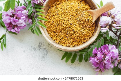 Healthy bee pollen grains.  Bee pollen on a bowl and acacia flowers