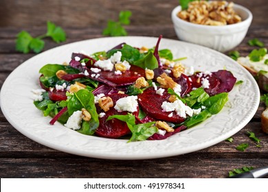 Healthy Beet Salad With Fresh Sweet Baby Spinach, Kale Lettuce, Nuts, Feta Cheese And Toast Melted