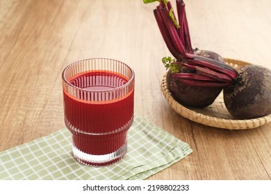 Healthy Beetroot Juice, cold pressed juice, served in glass with fresh beetroot.

