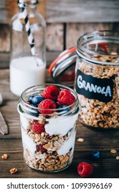 Healthy Blueberry And Raspberry Parfait With Greek Yogurt In Glass Mason Jar On Rustic Wood Background