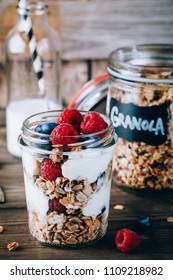 Healthy Blueberry And Raspberry Parfait With Greek Yogurt In Glass Mason Jar On Rustic Wood Background