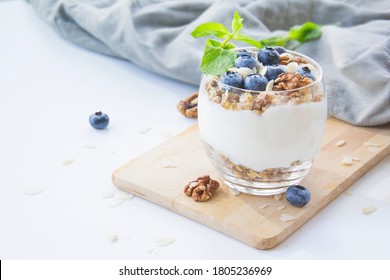 Healthy Blueberry And Walnut Parfait In A Glass On A White Background