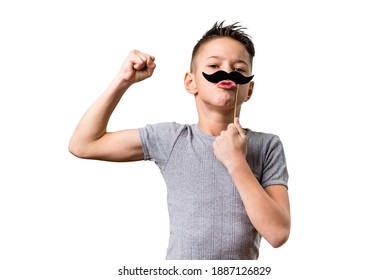 Healthy Boy Showing Muscles.Concept Of A Young Boy Striving To Be Tough Adult. Proud Kid Showing Biceps And Fake Mustache Isolated On Pure White Background