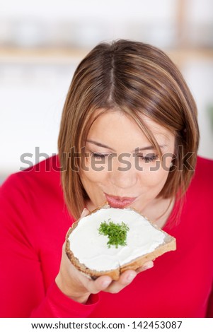 Healthy bread with cress for breakfast eaten by a pretty girl