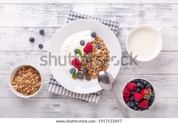 Healthy breakfast with baked granola and\
greek yogurt. Assorted fresh berries -\
Image