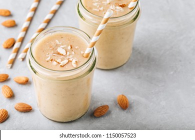 Healthy Breakfast. Banana Almond Smoothie With Cinnamon And Oat Flakes And Coconut Milk In Glass Jars