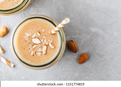 Healthy Breakfast. Banana Almond Smoothie With Cinnamon And Oat Flakes And Coconut Milk In Glass Jars