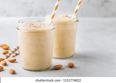 Healthy Breakfast. Banana Almond Smoothie With Cinnamon And Oat Flakes And Coconut Milk In Glass Jars