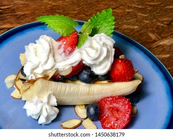 Healthy Breakfast Banana Split On Blue Plate