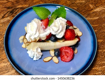 Healthy Breakfast Banana Split On Blue Plate