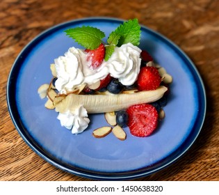 Healthy Breakfast Banana Split On Blue Plate