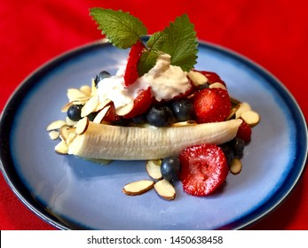 Healthy Breakfast Banana Split On Blue Plate