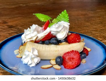 Healthy Breakfast Banana Split On Blue Plate