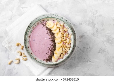 Healthy Breakfast  Berry Smoothie Bowl Topped With Banana, Cashew And Chia Seeds With Copy Space