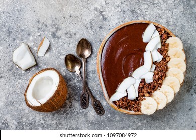 Healthy Breakfast Bowl. Chocolate Banana Smoothie Bowl With Coconut Flakes, Granola, Banana Slices. Top View, Flat Lay, Overhead