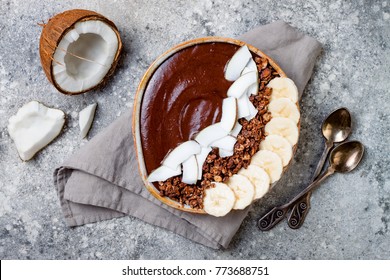 Healthy Breakfast Bowl. Chocolate Banana Smoothie Bowl With Coconut Flakes, Granola, Banana Slices. Top View, Flat Lay, Overhead