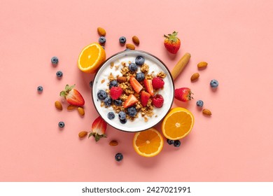 Healthy breakfast bowl with ingredients granola fruits Greek yogurt and berries on a pink background top view. Weight loss, healthy lifestyle and eating concept - Powered by Shutterstock