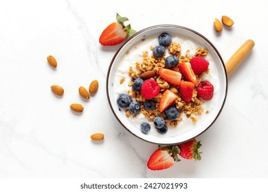 Healthy breakfast bowl with ingredients granola fruits Greek yogurt and berries top view. Weight loss, healthy lifestyle and eating concept - Powered by Shutterstock