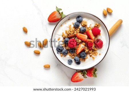 Healthy breakfast bowl with ingredients granola fruits Greek yogurt and berries top view. Weight loss, healthy lifestyle and eating concept