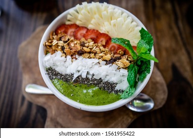 

Healthy Breakfast Bowl: Tropical Fruits Smoothie With Chia Seeds,  Banana Pineapple, Green Matcha. Healthy Food Concept. Flat Lay, Top View, Close Up