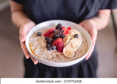 Healthy breakfast brunch oatmeal. Healthy lifestyle. Fruits and berries. Strawberry, raspberry, blackberry, blueberry, banana. Maple syrup drizzle. Cinnamon topping. White plate. Weekday breakfast - Powered by Shutterstock