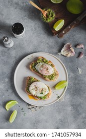 Healthy Breakfast Concept. Two Toast With Whole Grain Bread With Avocado Guacamole And  Poached Egg, Garlic And Lime. Ingridients For Home Cooking. Healthy Lifestyle. Flatlay 