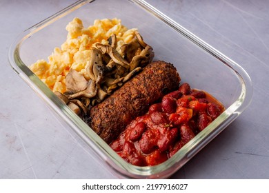 A Healthy Breakfast Containing Scrambled Eggs, Mushrooms, Cutlet And Red Beans